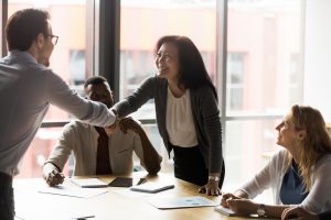Middle-aged,Asian,Korean,Ethnicity,Businesswoman,Shake,Hands,With,European,Millennial