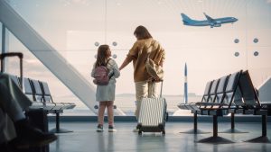 Airport,Terminal:,Beautiful,Mother,And,Cute,Little,Daughter,Wait,For