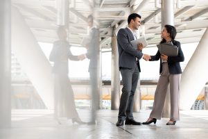 Indian,Businessman,Greeting,And,Making,Handshake,With,A,Businesswoman,Outdoors