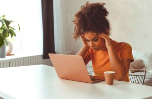 Tired,Flustrated,African,Descent,Young,Girl,Sitting,At,Desk,In