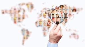 Hand,With,Magnifying,Glass,Searching,For,Suitable,Staff,On,World